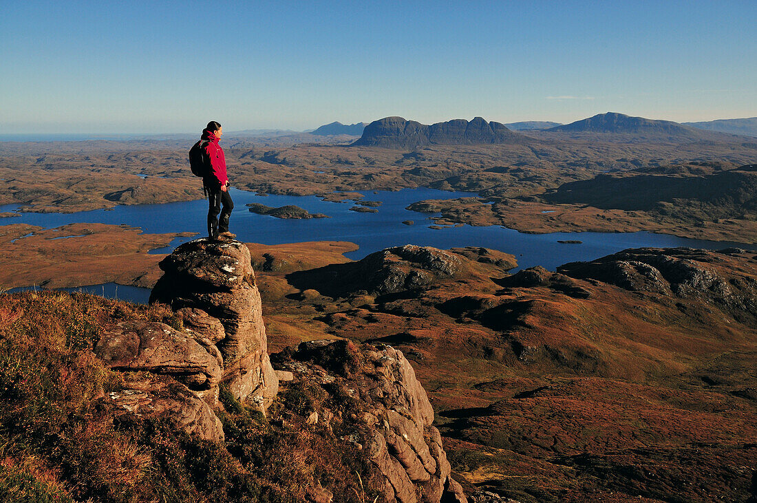 Female hiker at Stac Pollaidh, Suilven in background, Inverpolly Nature Reserve, Highlands, Scotland, Great Britain