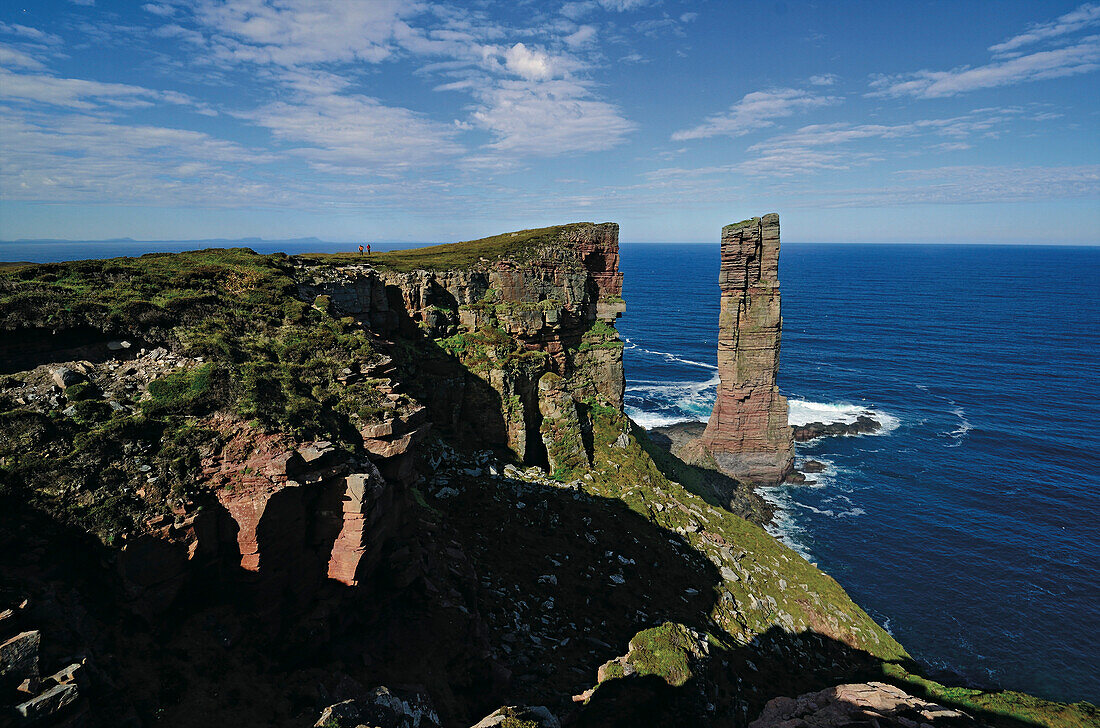 Hikers on cliff coast, Old Man of Hoy, Hoy, Orkney Islands, Scotland, Great Britain