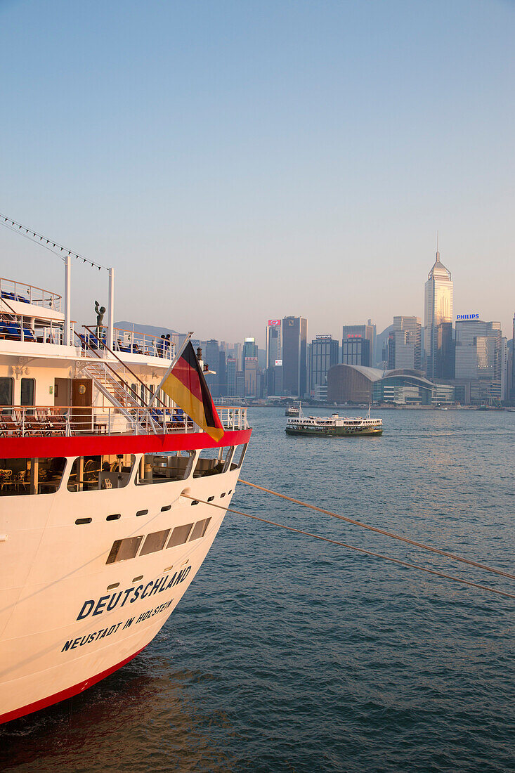 Cruise ship MS Deutschland, Reederei Peter Deilmann, at Ocean Terminal with Star Ferry in Hong Kong harbor and skyline in the distance, Tsim Sha Tsui, Kowloon, Hong Kong