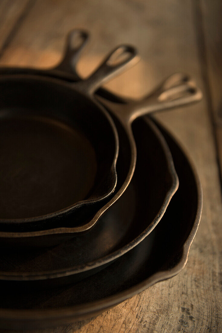 Empty cast iron pans on wooden board, Richmond, VA, USA