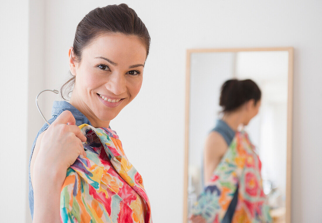 Caucasian woman trying on clothes in store, Jersey City, New Jersey, USA