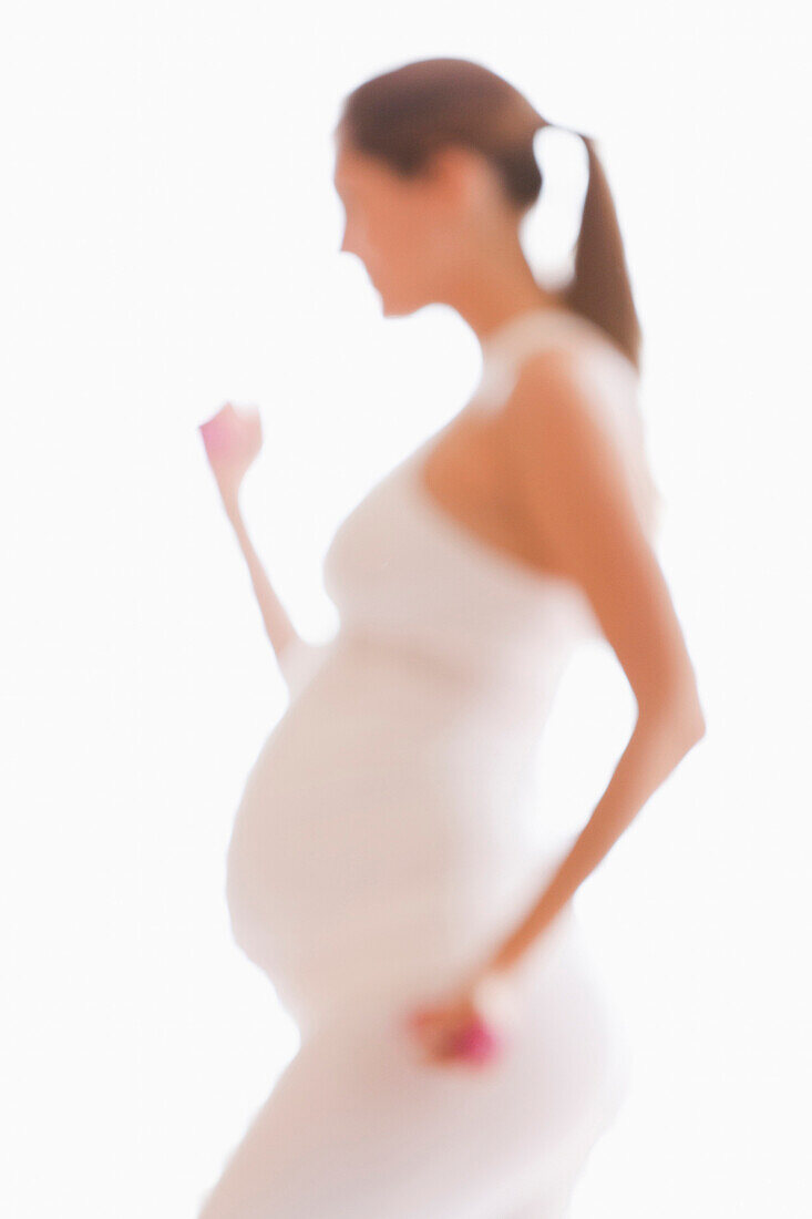 Defocused view of pregnant woman lifting weights, Houston, TX, USA