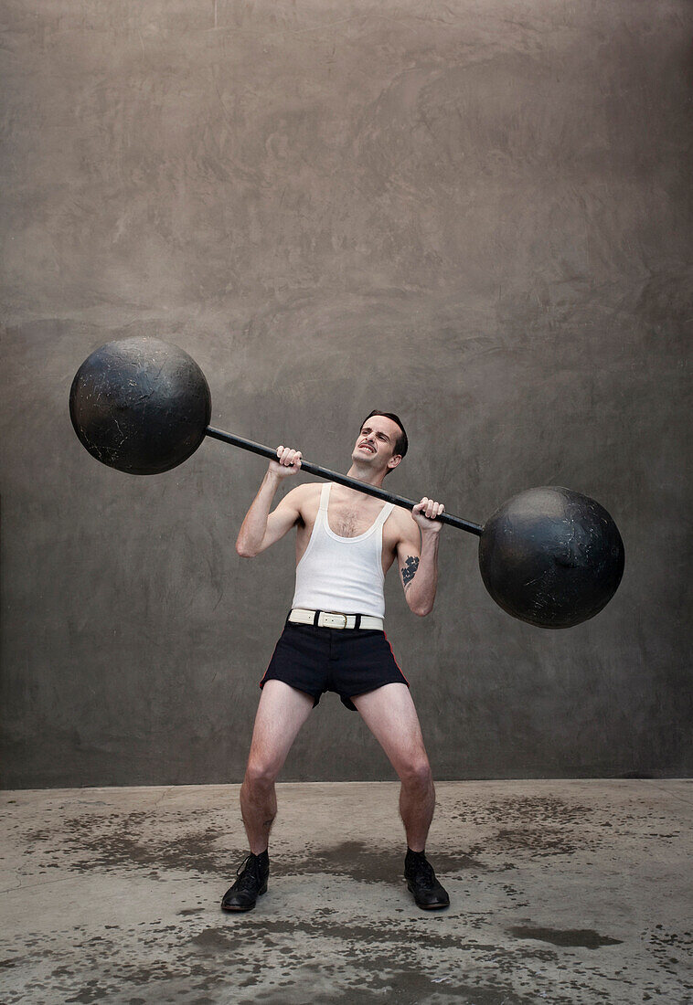Skinny Caucasian weight lifter straining, Los Angeles, CA, USA