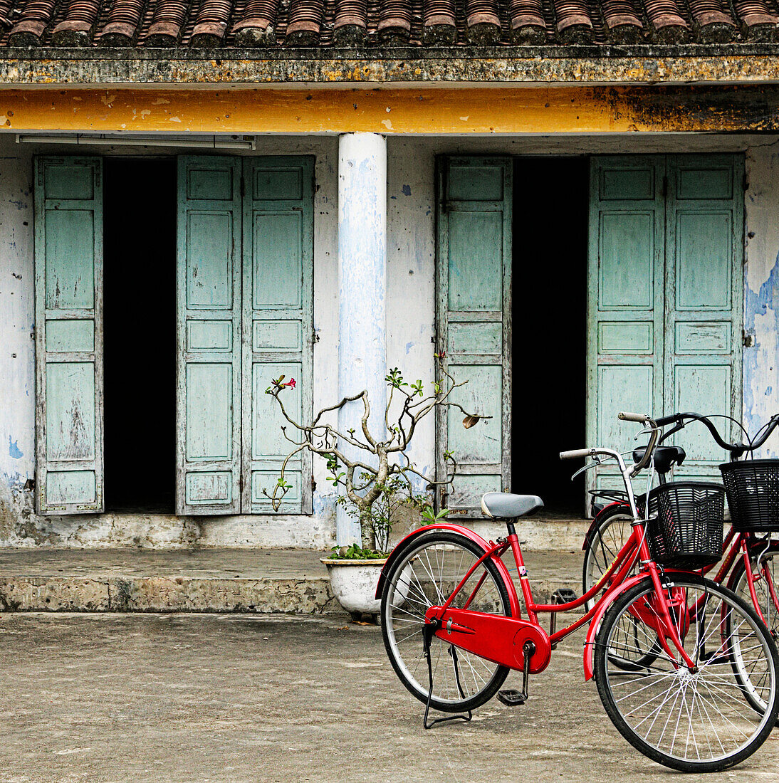 Red Bikes Parked in Front of a Weathered Building, Hoi An, Vietnam