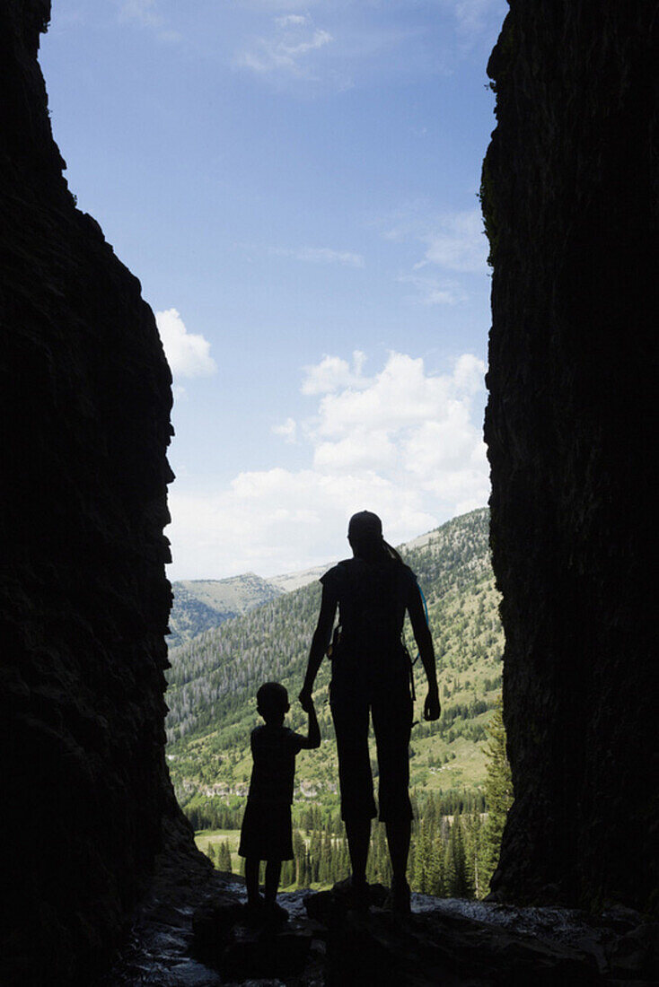 Caucasian mother and son exploring cave, Jackson, Wyoming, USA