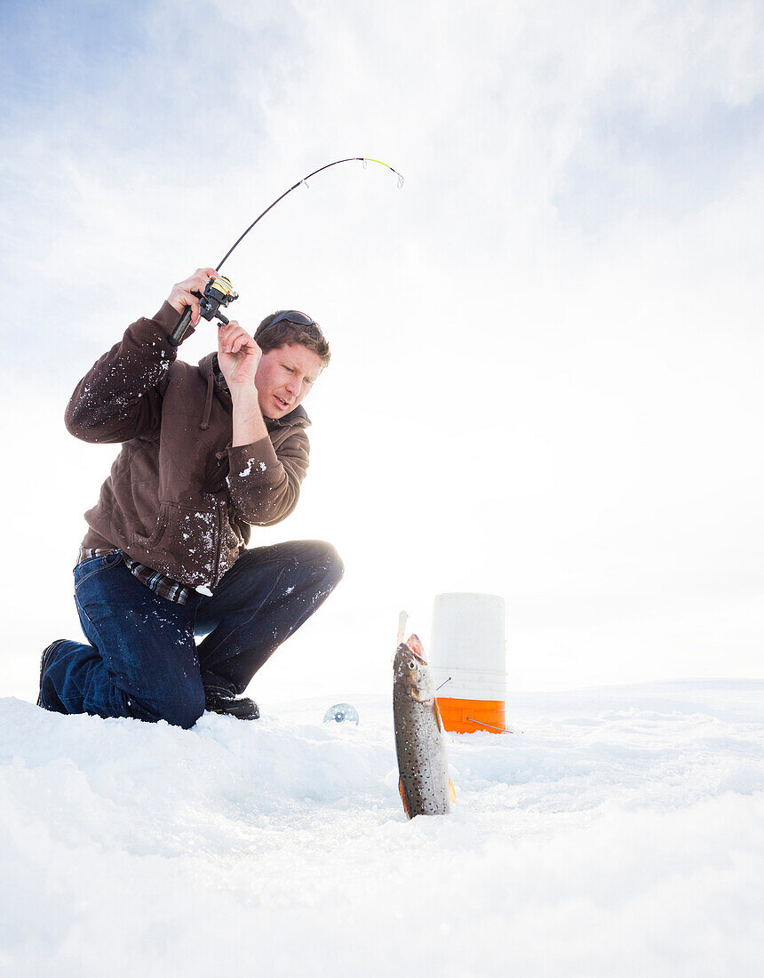 Caucasian man ice fishing, Heber, Utah, USA