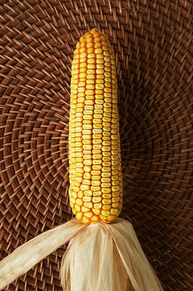 Close up of corn cob on woven placemat, Newmarket, ON, Canada