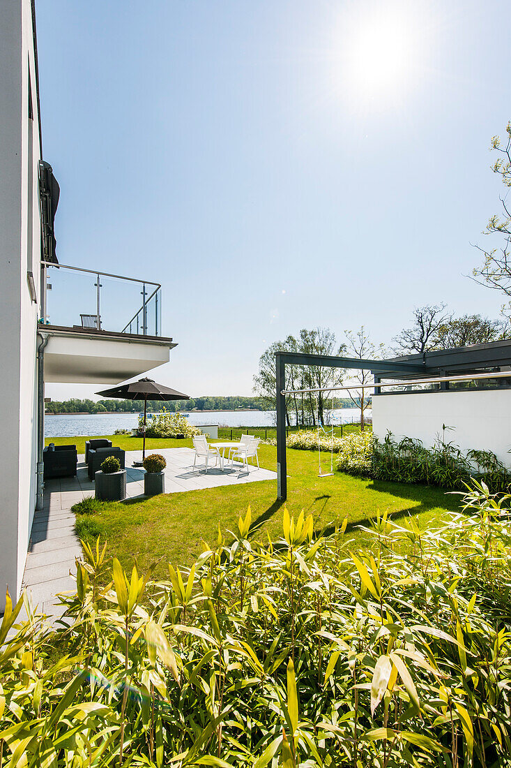 Terrace with water view at a modern architecture style villa, Brandenburg, Germany