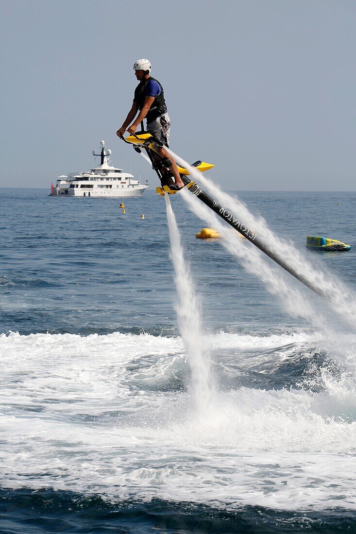 Europe, Principality of Monaco, Montecarlo Beach resort and hotel property of SBM (Societe des Bains de Mer), practising the new aquatic sport called Flyboard.