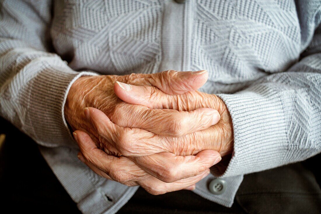Close up of the hands of a centennial woman in a elderly people home.
