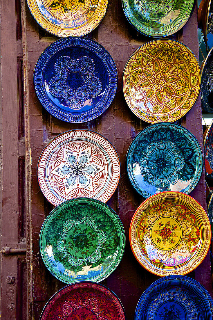 Earthenware plates and dishes from Fez, for sale in the street of the Medina, Marrakech, Morocco, North Africa.