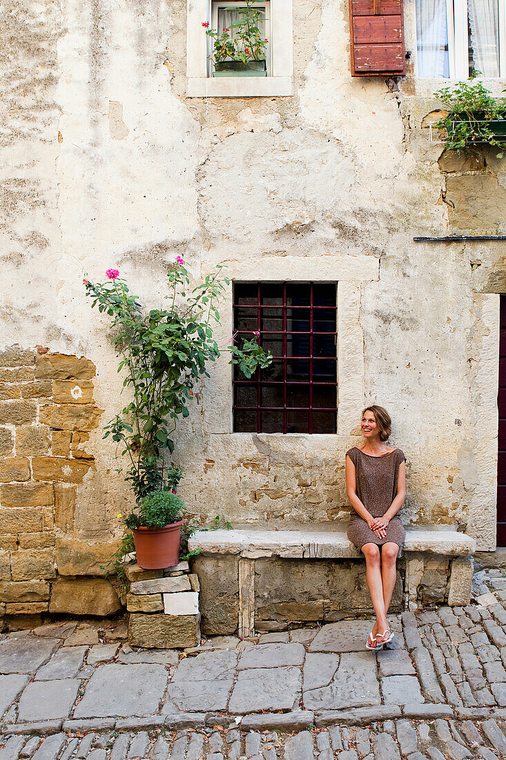 Woman outside traditional house, Groznjan, Istria, Croatia