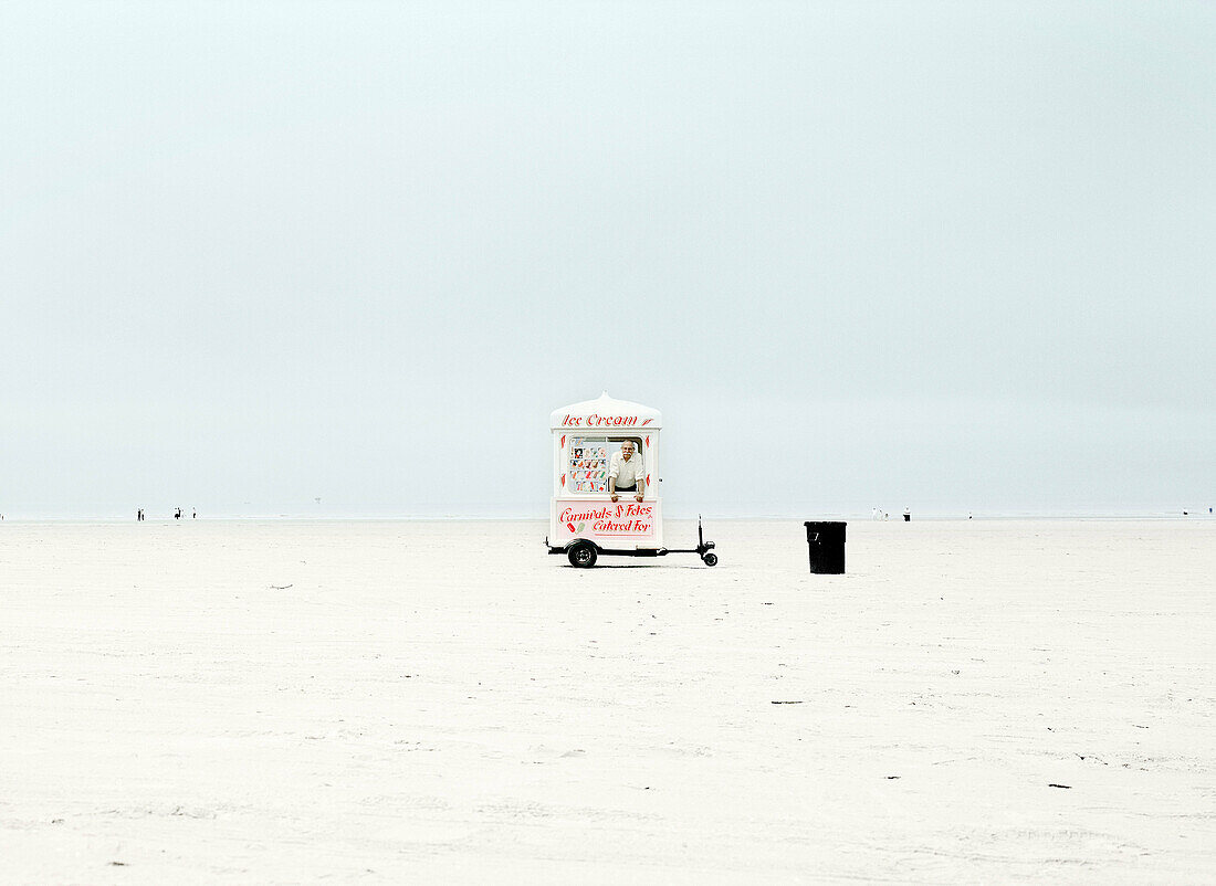 Man standing inside ice cream van on remote beach