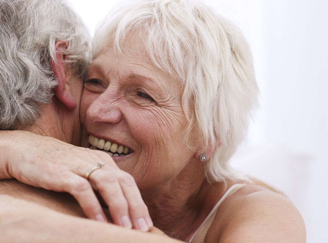 Senior couple embracing, close up