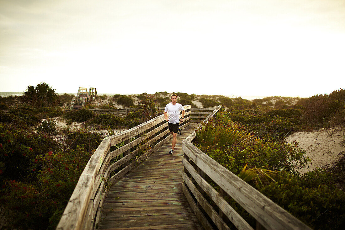 Man running along boardwalk