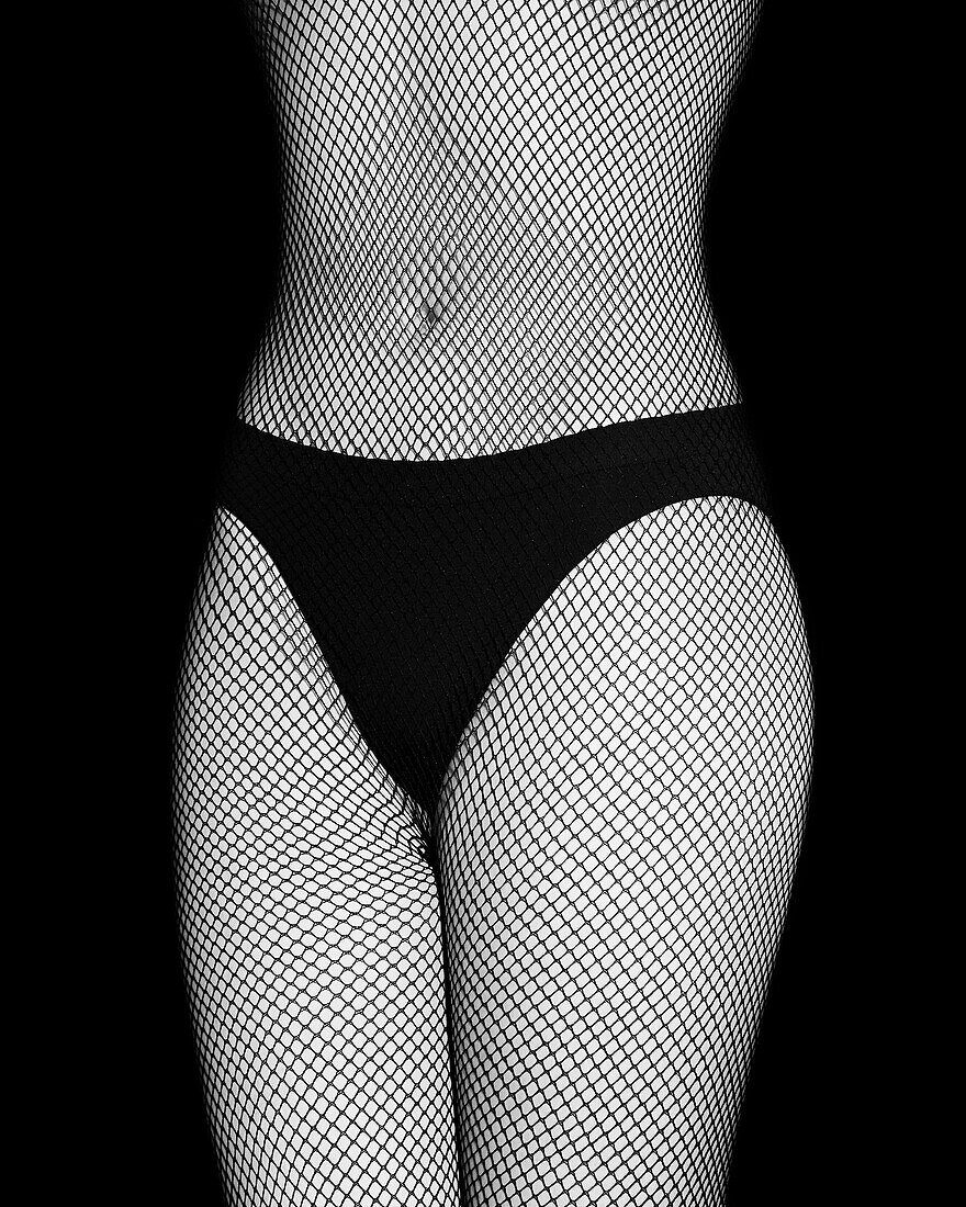 Mid section of woman wearing fishnet bodystocking