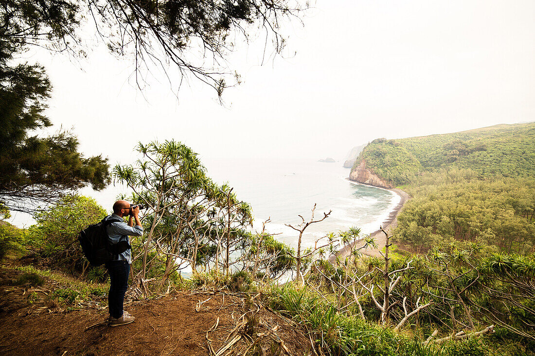 Mid adult man photographing coastline