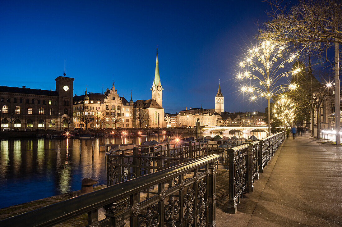 Christmas Illuminations along the river Limmat, Town Hall, Fraumunster and St. Peter's Church, Zurich, Switzerland