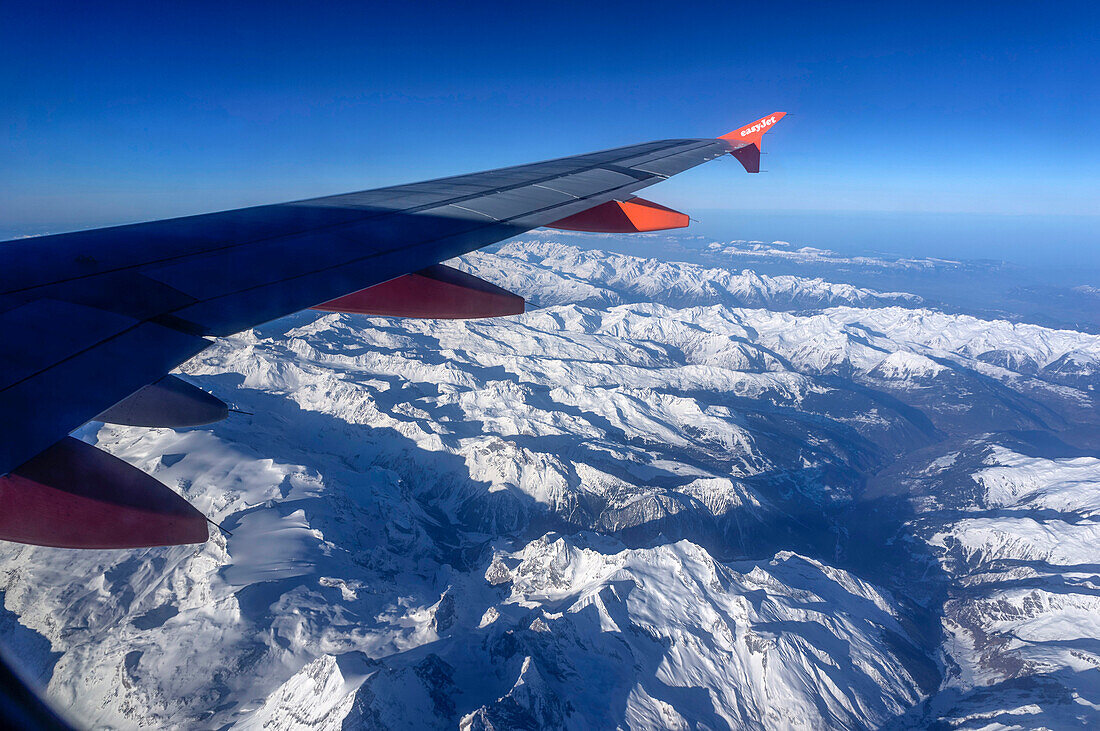 Aerial view from an aeroplane over the snowy Alps, Alps, Europe