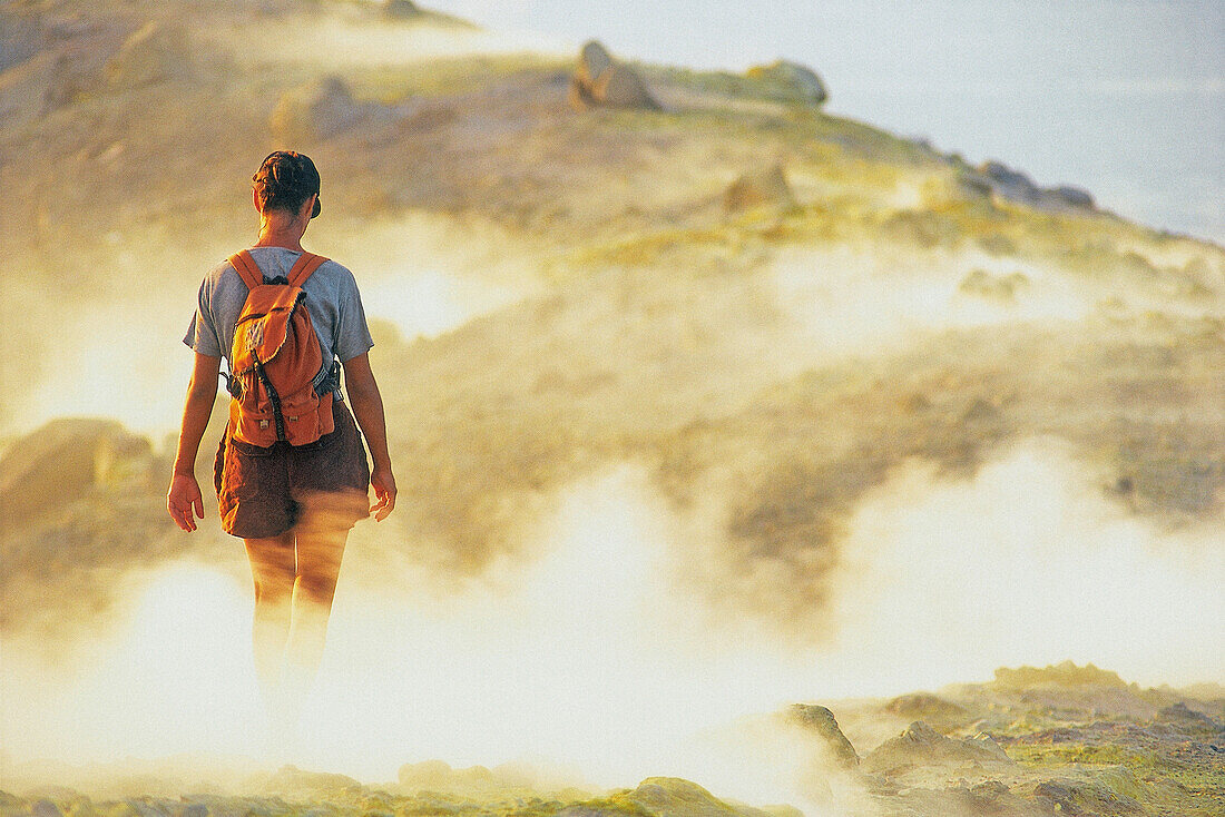 Person walking through sulphur vapour, Caldera, Gran Cratere, Vulcano, Aeolian Islands, Italy