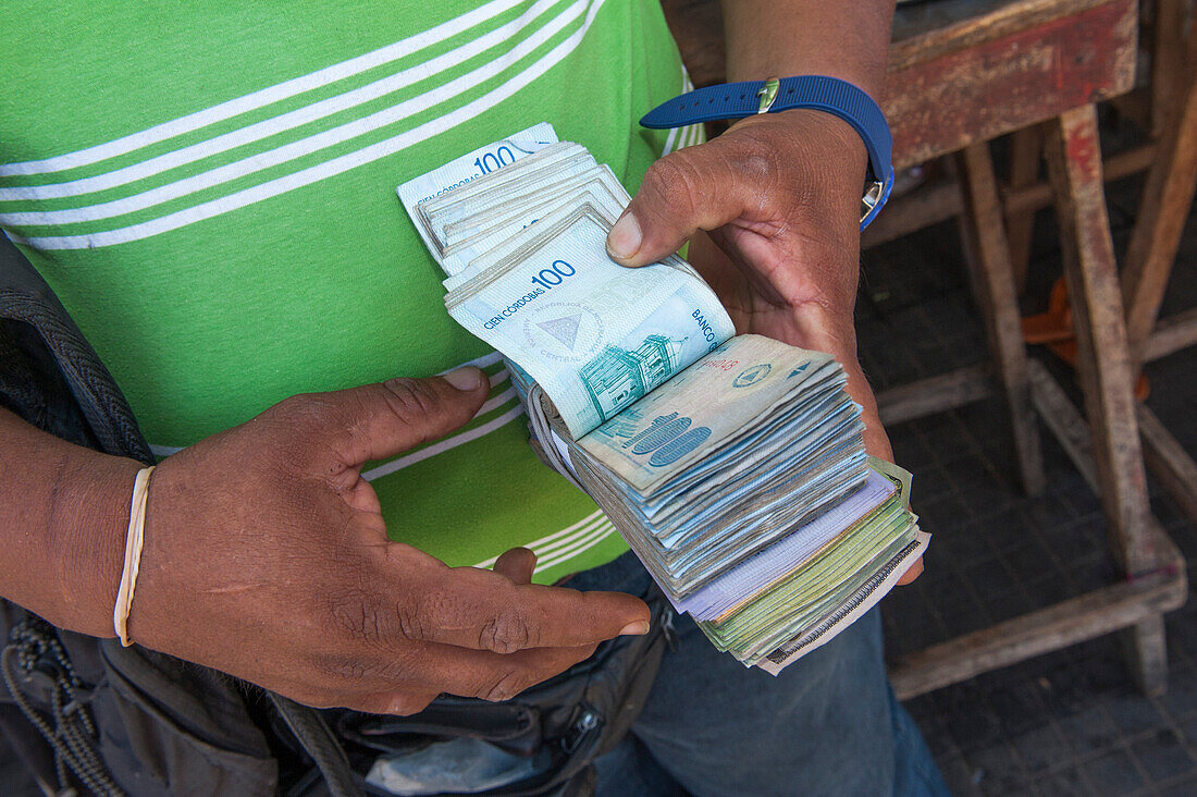 Mann mit einem Geldbündel auf einem Schwarzmarkt, Leon, Leon, Nicaragua