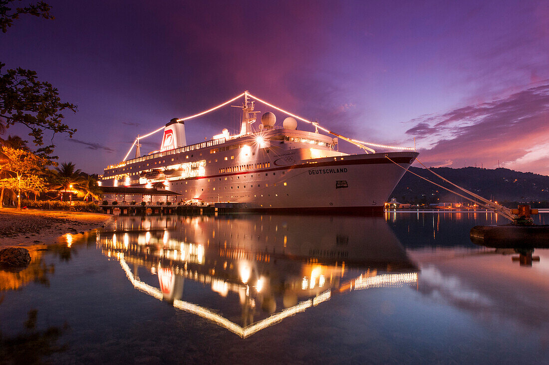 Illuminated cruiser in harbor at sunset, Port Antonio, Portland, Jamaica