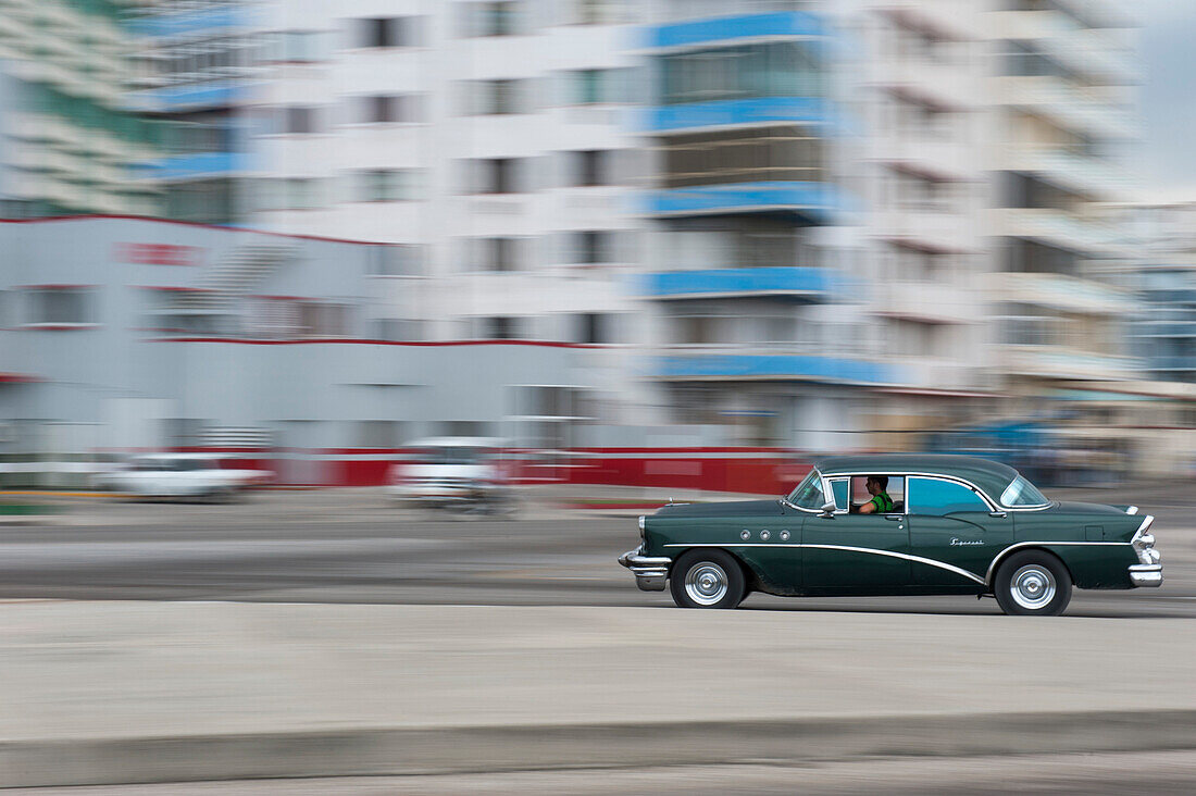 Vintage American car passing Malecon sea drive, Havana, La Habana, Cuba