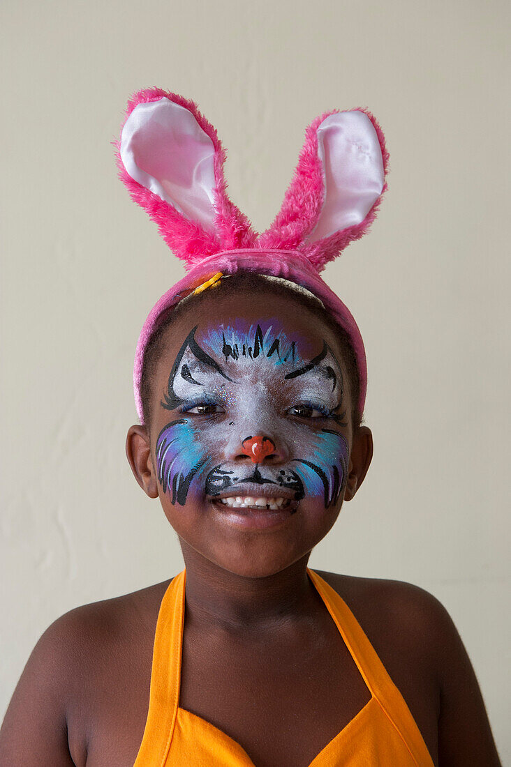 Girl with facial painting wearing rabbit ears, St. John's, Antigua, Antigua and Barbuda