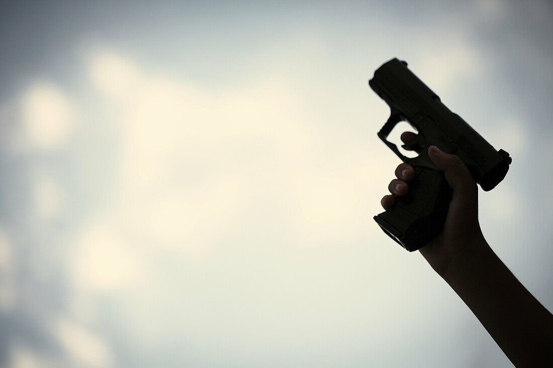 Man holding a pistol.