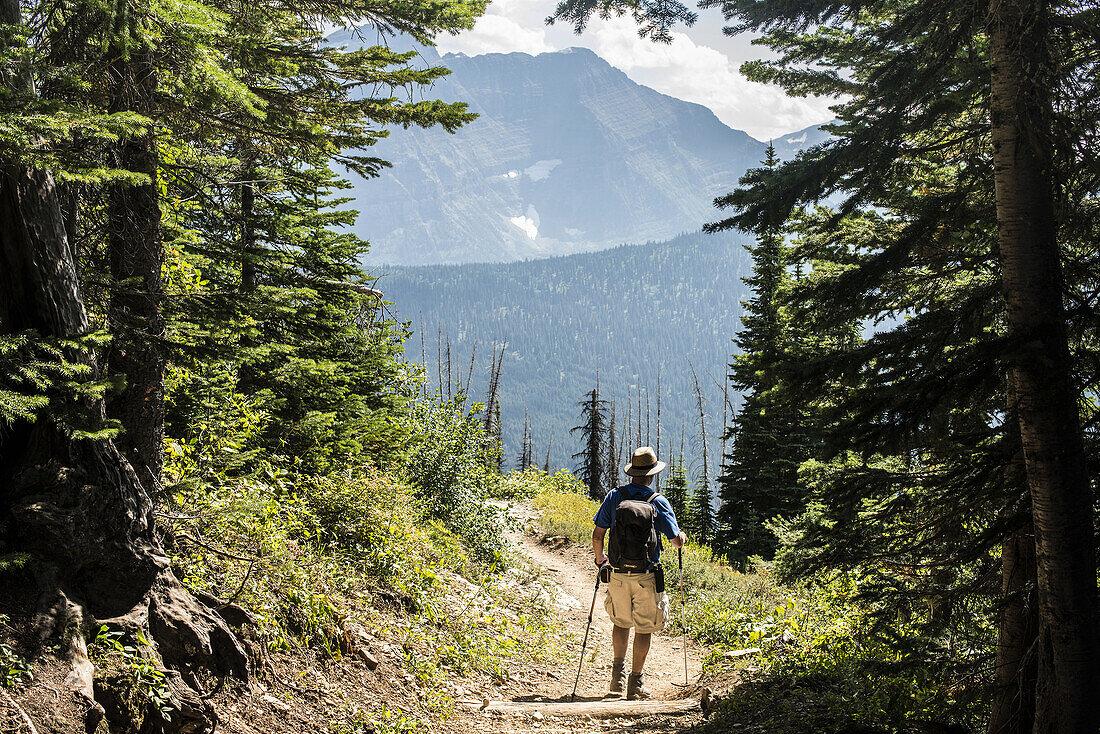 A man hikes on The Highline Trail, Glacier National Park, Montana, USA.