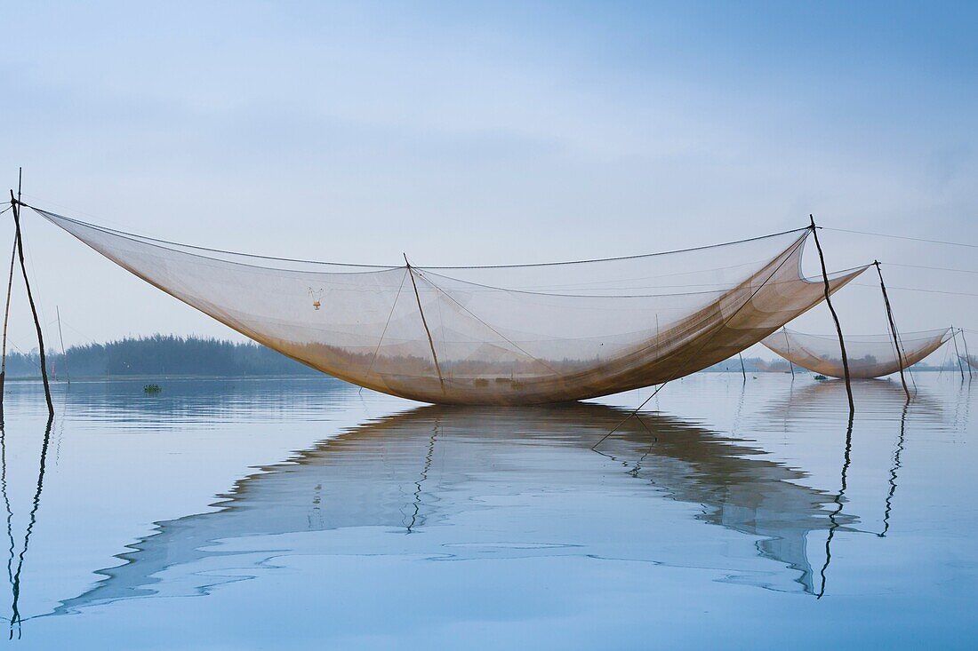 Large fishing nets in the Thu Bon River near Hoi An, Vietnam, Asia.