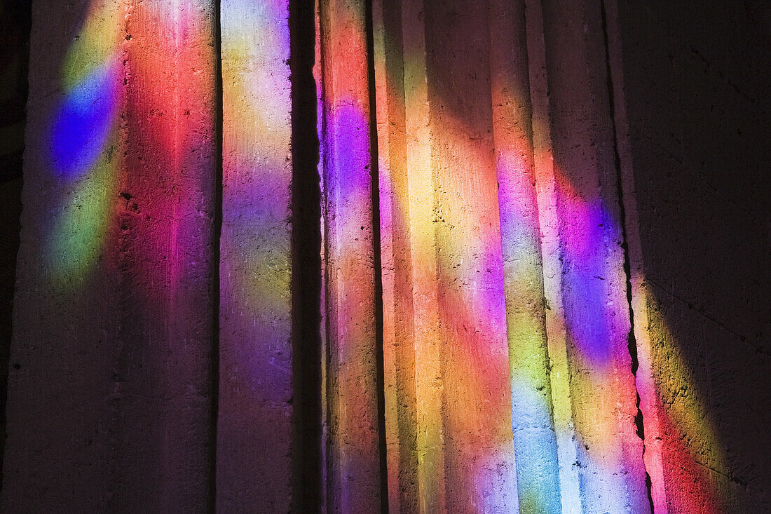 Colourful light reflections on a cement pillar, Cordoba, Spain, Europe.