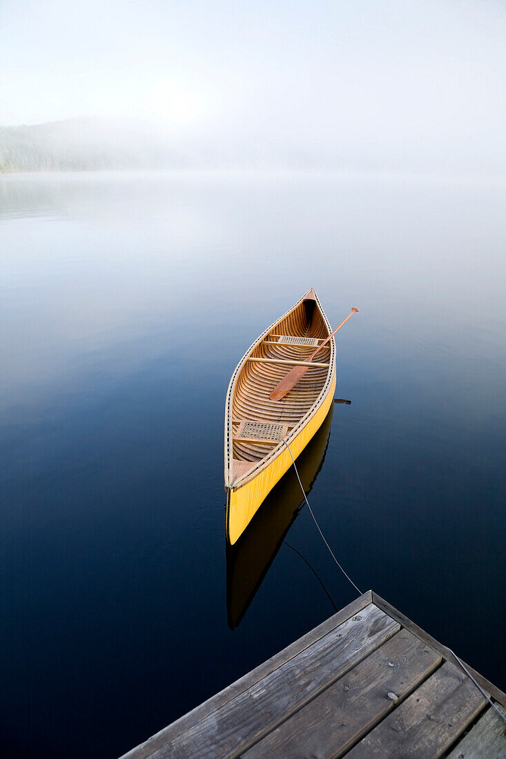 Yellow Canoe Tied To Cottage Dock, Algonquin Park, Ontario