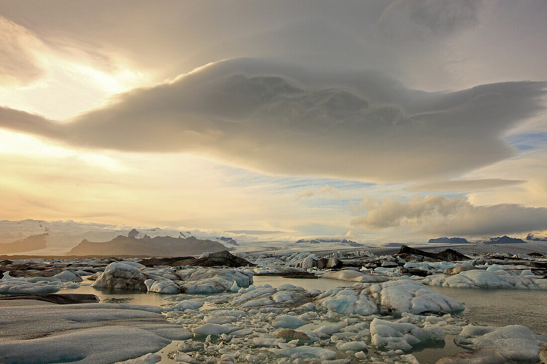 The Melting Icebergs Of Jokulsarl On The Glacial Lagoon In Southern Iceland With Lenticular Clouds Above Them