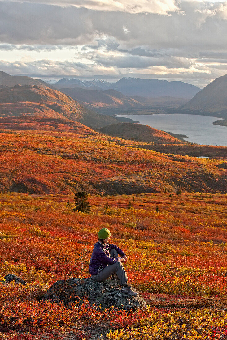 'Woman Sitting On Rock Near Fish Lake; Whitehorse Yukon Canada'