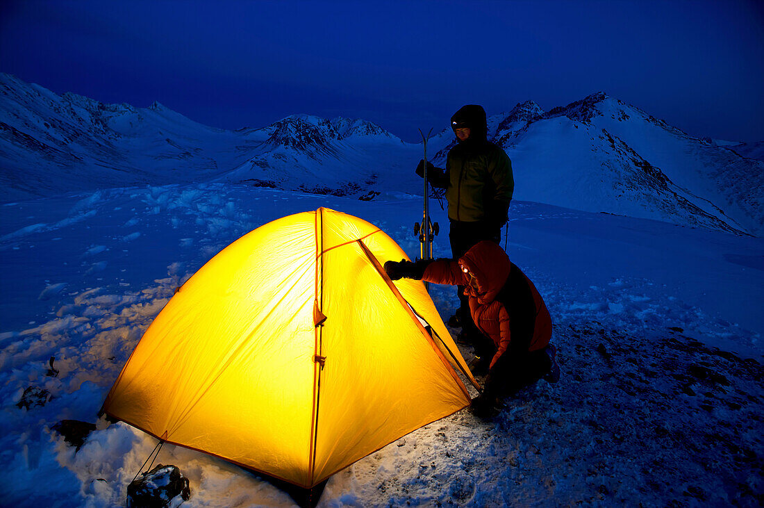 Climbers Enter A Lit Tent To Spend The Night At Camp In The Chugach Mountains Near Anchorage, Chugach State Park, Southcentral Alaska, /Nspring