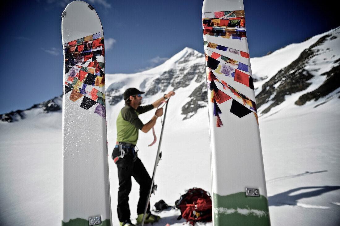 Backcountry Skier Prepares Skis For Descent Of The North Side Of Mt. Chamberlin, Brooks Range, Anwr, Arctic Alaska, Summer