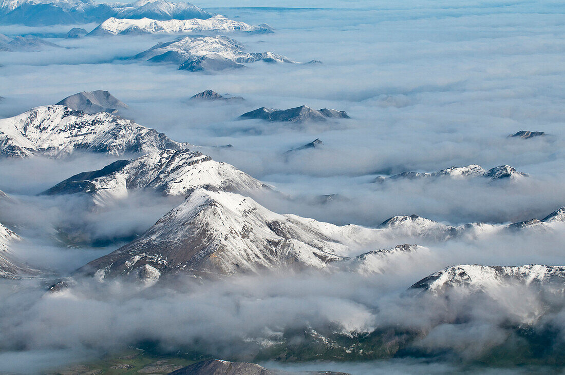 Aerial View Of Fog Rolling Over The Northern Edge Of The Brooks Range In Gates Of The Arctic National Park & Preserve, Arctic Alaska, Summer
