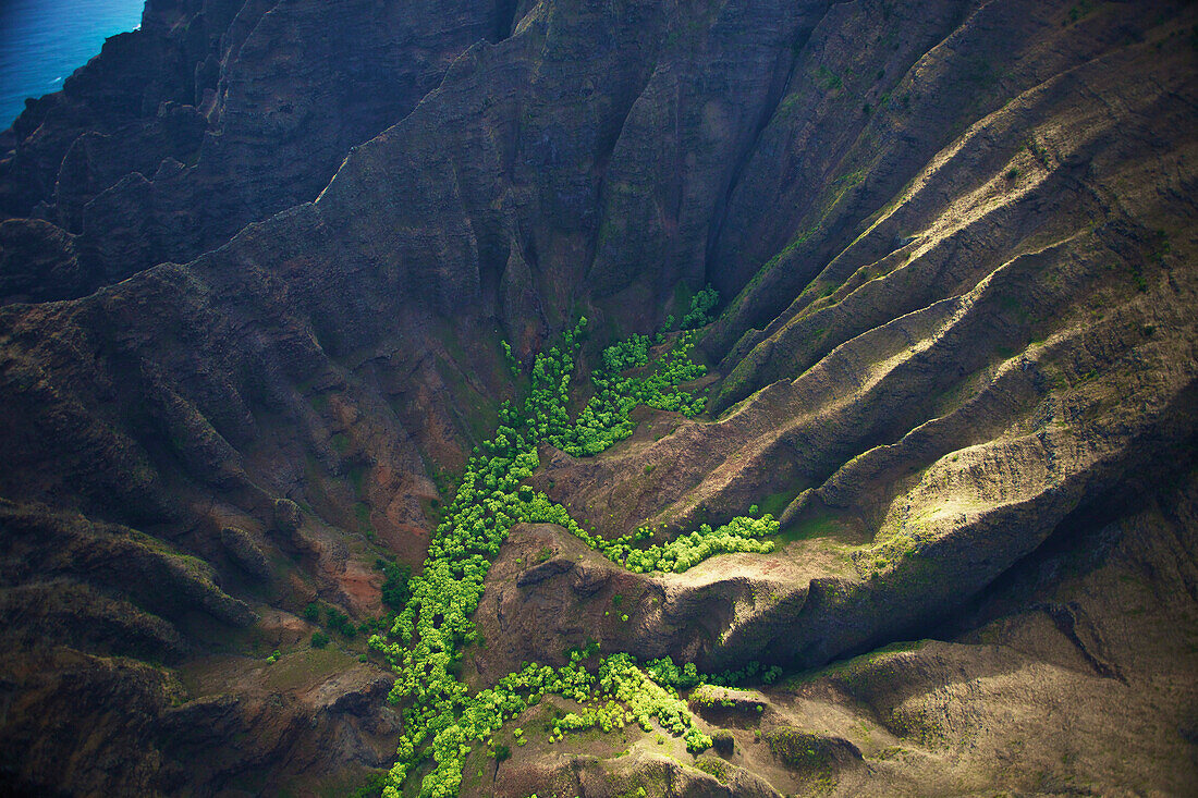 'Aerial view of the rugged landscape along the coast of an hawaiian island; Hawaii, United States of America'