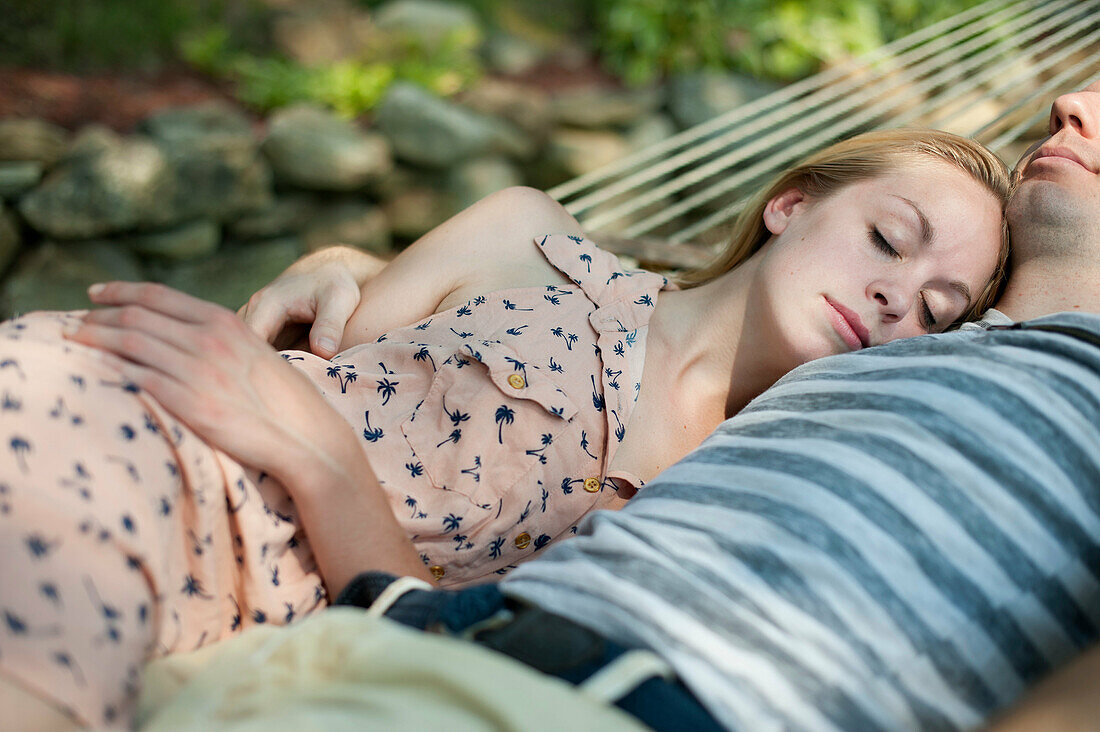Young couple asleep in hammock