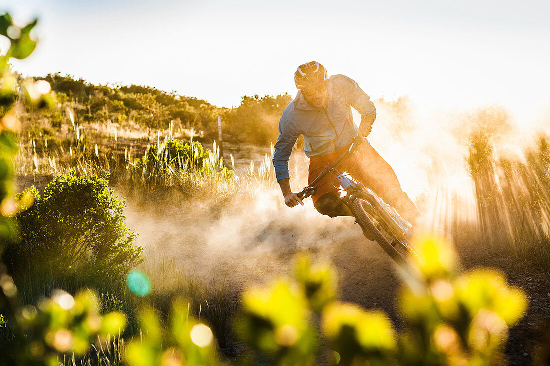 Young man mountain biking, Monterey, California, USA