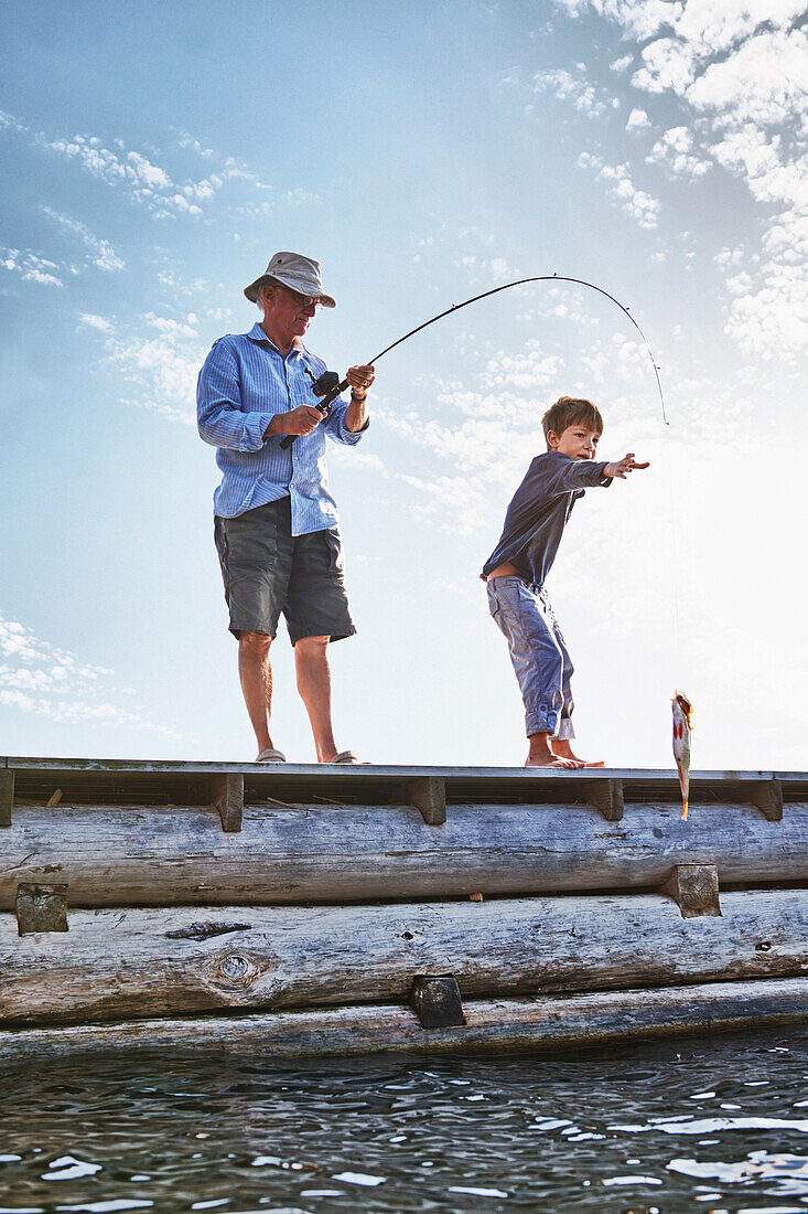 Grandfather and grandson fishing, Utvalnas, Sweden