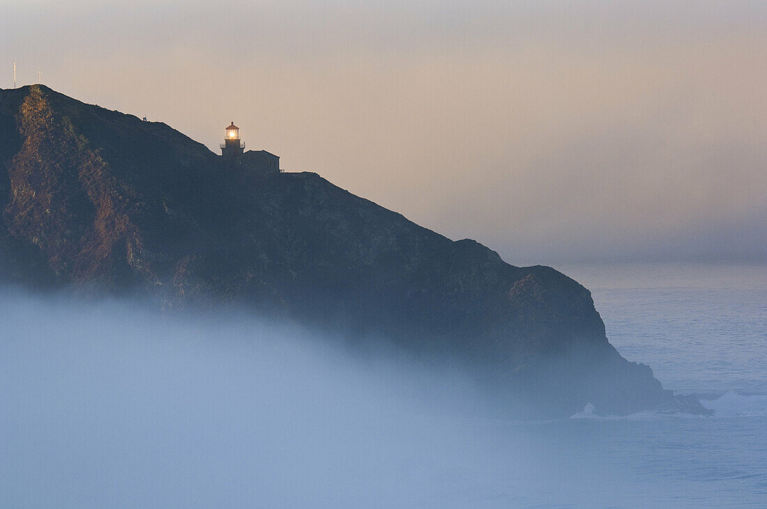 Point Sur Lighthouse and morning fog at sunrise, Big Sur, Monterey County coast, California.