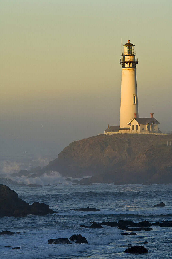 Waves and coastal rocks at Pigeon Point Lighthouse at sunrise, San Mateo County coast, California.