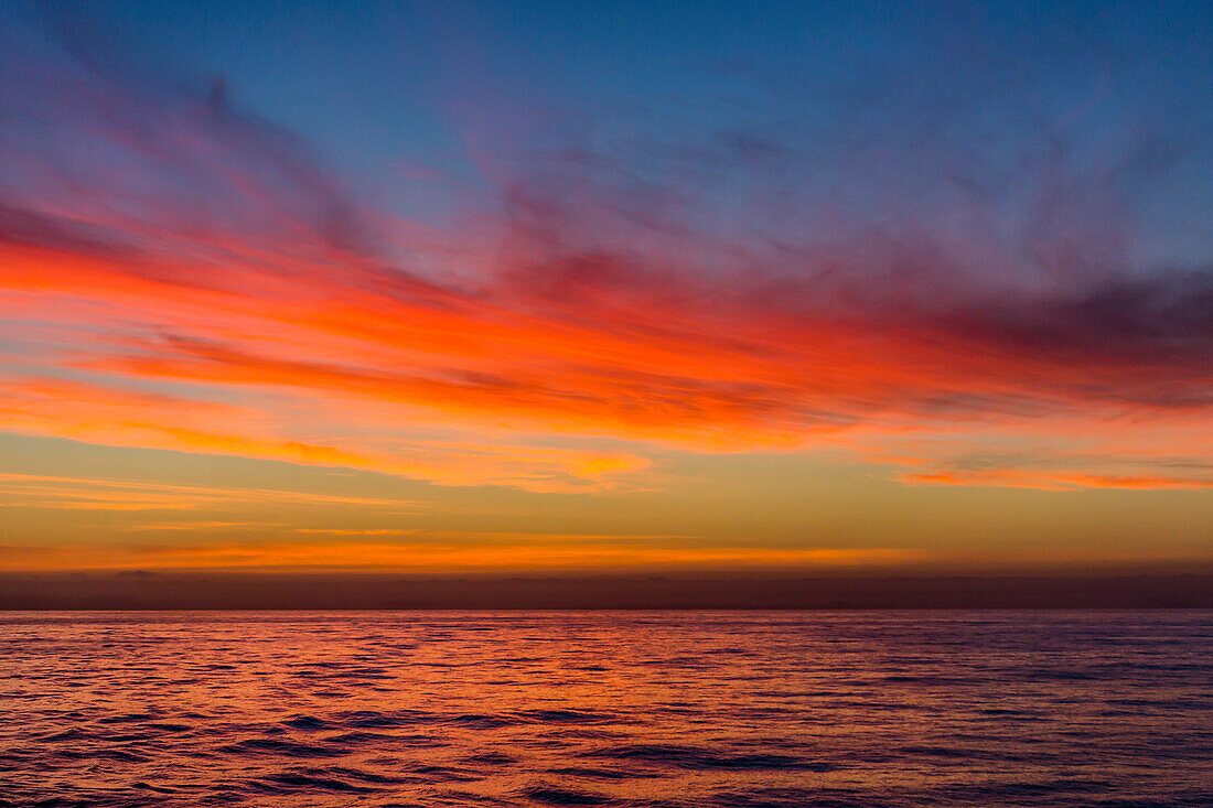 Sunrise off the coast of Akaroa, South Island, New Zealand, Pacific