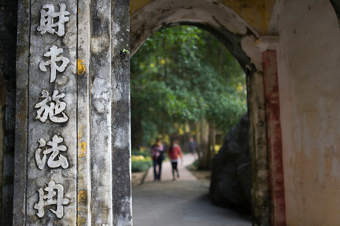 Entrance of a Buddist temple with vietnamese sings near Tam Coc, Ninh Binh, Vietnam