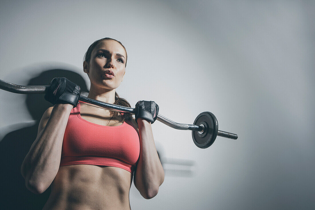 Caucasian woman lifting barbell, Saint Louis, Missouri, USA