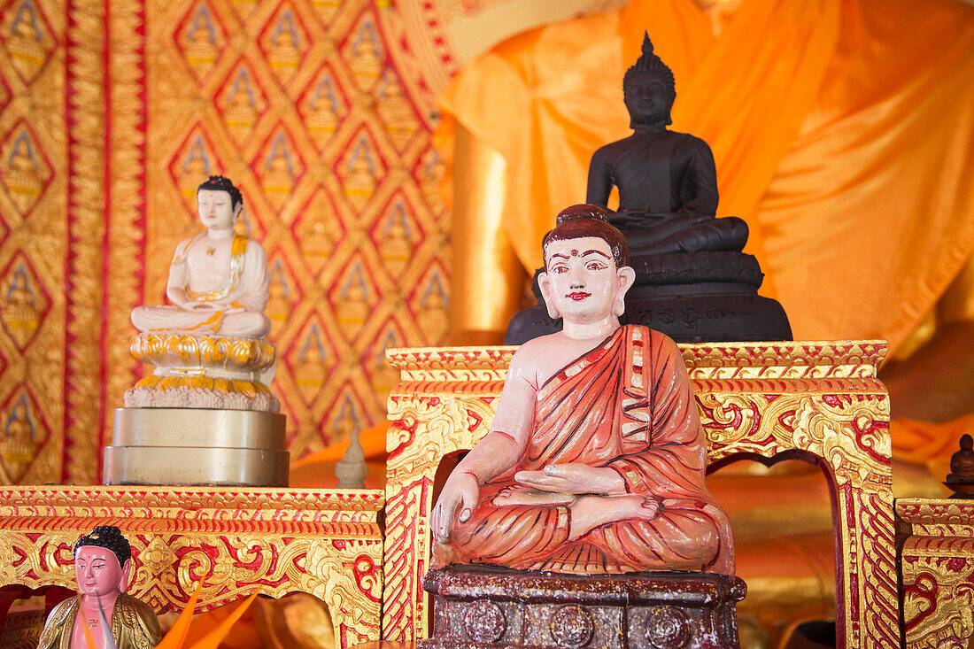 Ornate Buddha statues in temple, George Town, Penang, Malaysia