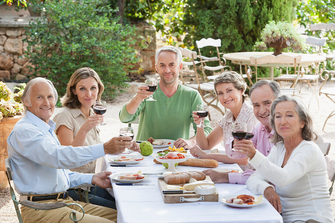 Friends eating together outdoors, Palma de Mallorca, Balearic Islands, Spain