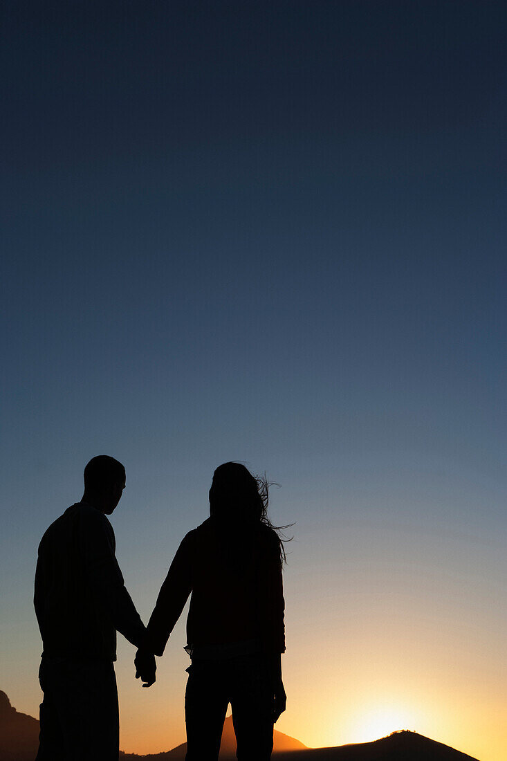 Silhouette of Caucasian couple holding hands, Cape Town, Western Cape, South Africa